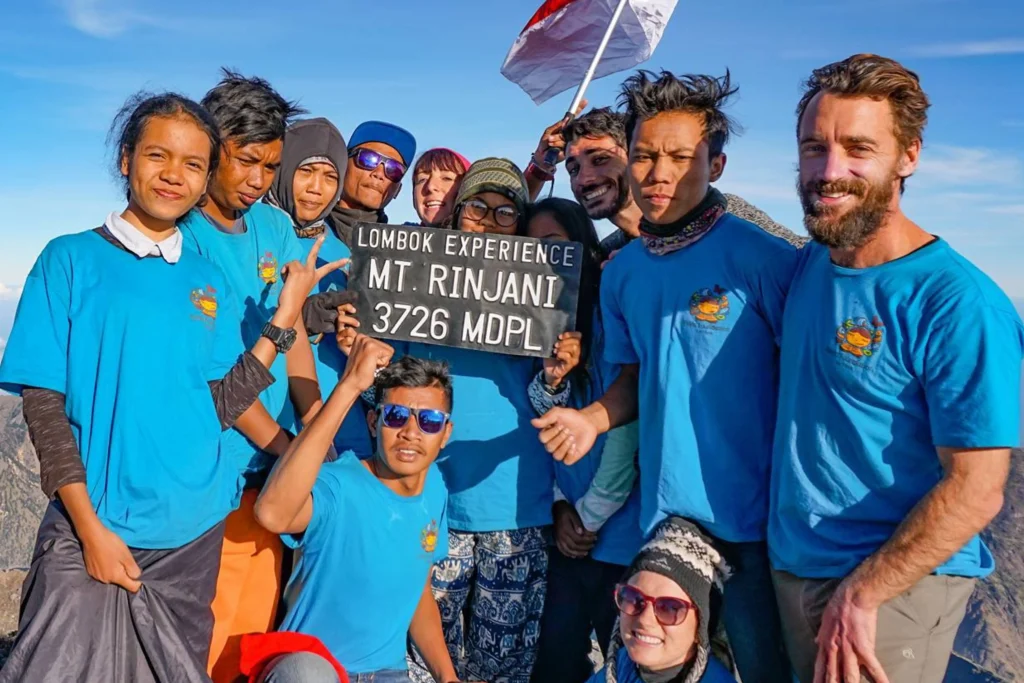 Students from the Pelita Foundation stand on the summit of Mount Rinjani.
